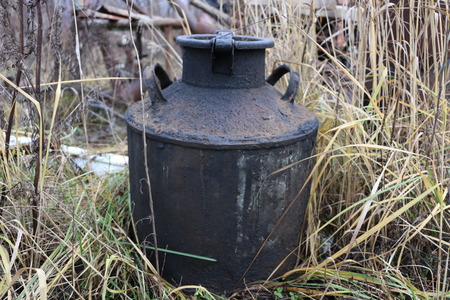 old abandoned in the traffic rusty Soviet milk canの写真素材