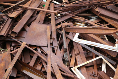 a heap of rusty, broken and crushed scrap of various steel and metal objectsの写真素材
