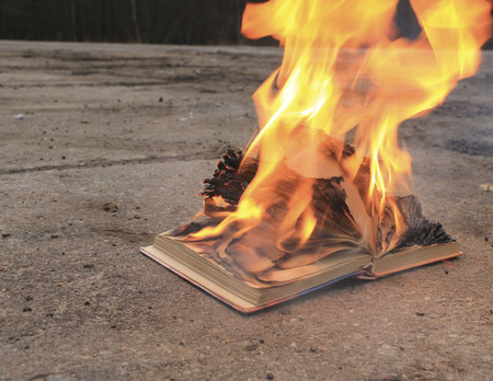 book with burning pages on a surfaceの写真素材