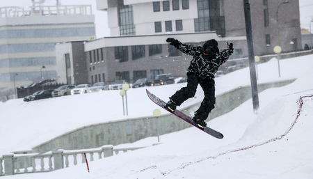 snowboarding. jump on snowboard. freestyle. jump from a springboard on a snowboard in the city. Grab. free ride の写真素材