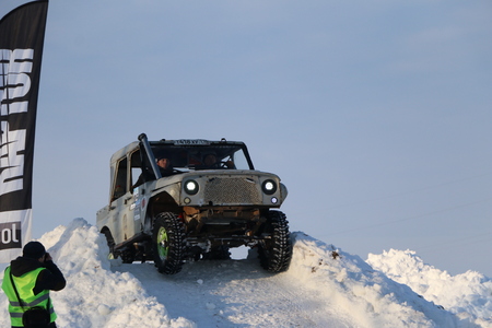 SALTAC-KOREM, RUSSIA - FEBRUARY 11, 2018: Winter auto show jeeps - Ice kneading 2018.
driving modified jeep off-road - monster truck rides through snow and snowdrifts, jumping  car from snowy slopesのeditorial素材