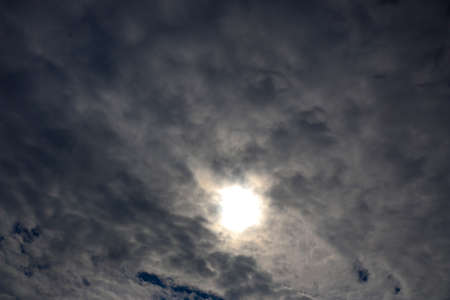 Spring. blue sky with fluffy white clouds. sun, sunlight through  clouds,  sky - spring changeable weather.
の写真素材