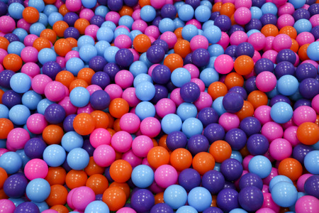 Colorful child balls. Multi-colored plastic balls. Achildren's playroom. Background texture of...