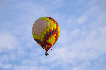 colorful hot air balloon against blue sky. hot air balloon is flying in white clouds. beautiful flying on hot air balloon.の写真素材