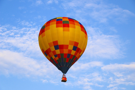 colorful hot air balloon against blue sky. hot air balloon is flying in white clouds. beautiful flying on hot air balloon.の写真素材
