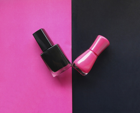 black nail polish on  pink background and pink nail polish on  black background. Emotional style in manicure.の写真素材