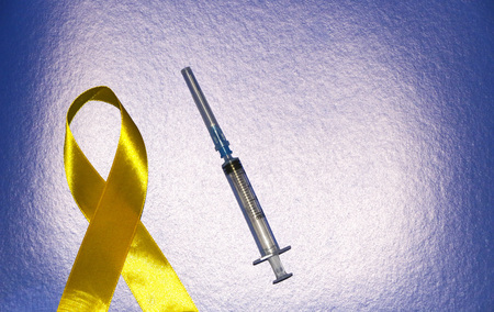 golden ribbon and medicine. concept -  symbol of childhood cancer, pediatric oncologyの写真素材