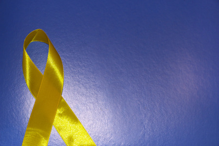 golden ribbon and medicine. concept -  symbol of childhood cancer, pediatric oncologyの写真素材