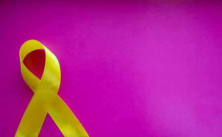 golden ribbon and medicine. concept -  symbol of childhood cancer, pediatric oncologyの写真素材