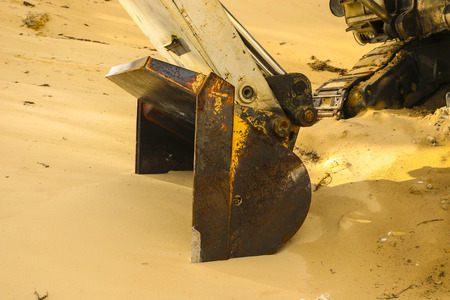 a huge excavator bucket digs sand in a sand quarry miningの写真素材