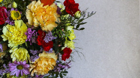 Bright colored spring bouquet on a light background, with a place for text.