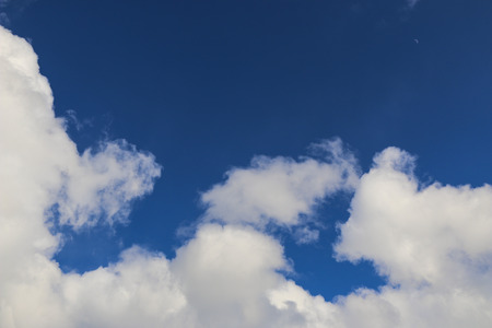 white fluffy clouds on a bright blue sky in Sunny weather