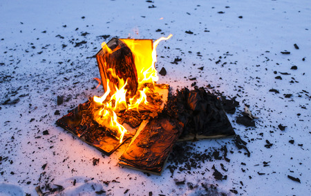 burning book in the snow. pages with the text in the open book burn with a bright flame.の写真素材