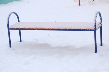 playground with swings, benches, slide and sports units in the snow.の写真素材