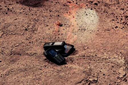 burnt mobile phones on a textural concrete background. Concept: Danger of using low-quality cell...