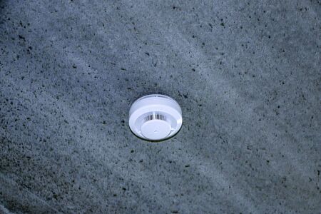 White plastic smoke detector for home and office,  fire alarm.