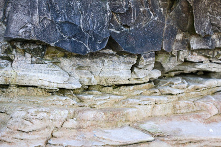 mountain textures of stones with interlayers of gypsum, colored quartz, clay, sand and other layers...