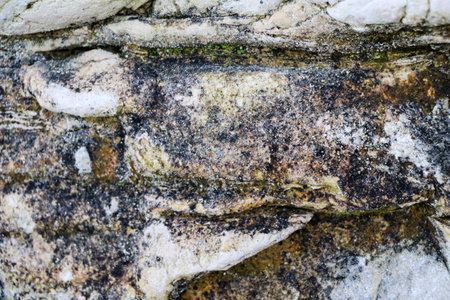 mountain textures of stones with interlayers of gypsum, colored quartz, clay, sand and other layers of various ores, with different textures, color and density, in a gypsum ore quarry.の写真素材