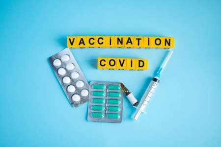 Various medicines on a blue background for Vaccination against Corona Virus. Concept of fight...