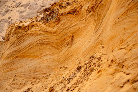 Textural sand, with a relief surface, multi-colored layers and different in size of granules, in an...