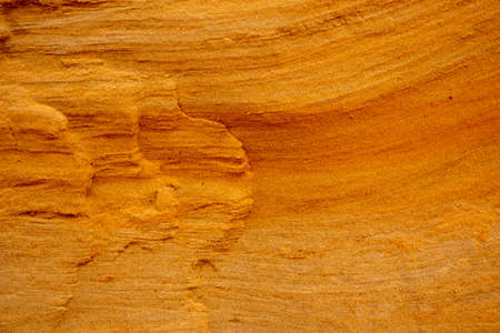 Textural sand, with a relief surface, multi-colored layers and different in size of granules, in an...