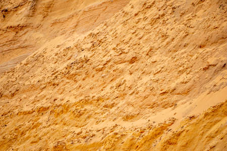 Textural sand, with a relief surface, multi-colored layers and different in size of granules, in an...