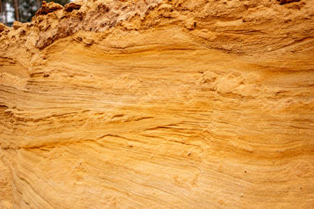 Textural sand, with a relief surface, multi-colored layers and different in size of granules, in an...