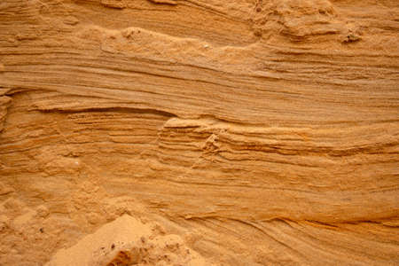 Textural sand, with a relief surface, multi-colored layers and different in size of granules, in an outdoor sand career, after mining ore and sand for construction.の写真素材
