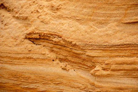 Textural sand, with a relief surface, multi-colored layers and different in size of granules, in an outdoor sand career, after mining ore and sand for construction.の写真素材