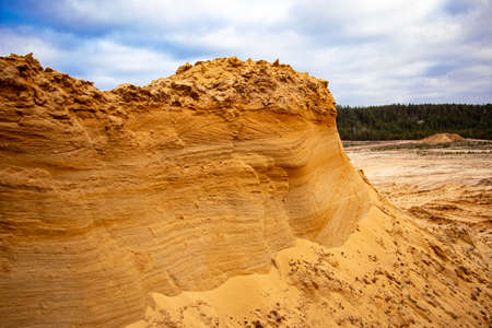Textural sand, with a relief surface, multi-colored layers and different in size of granules, in an outdoor sand career, after mining ore and sand for construction.の写真素材