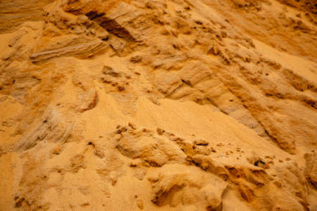 Textural sand, with a relief surface, multi-colored layers and different in size of granules, in an...