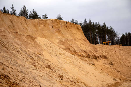 Textural sand, with a relief surface, multi-colored layers and different in size of granules, in an outdoor sand career, after mining ore and sand for construction.の写真素材