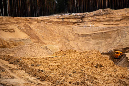 Textural sand, with a relief surface, multi-colored layers and different in size of granules, in an outdoor sand career, after mining ore and sand for construction.の写真素材