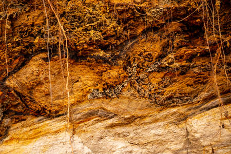 Textural sand, with a relief surface, multi-colored layers and different in size of granules, in an...
