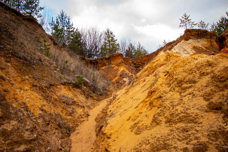 Textural sand, with a relief surface, multi-colored layers and different in size of granules, in an outdoor sand career, after mining ore and sand for construction.の写真素材