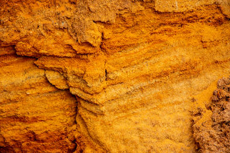 Textural sand, with a relief surface, multi-colored layers and different in size of granules, in an outdoor sand career, after mining ore and sand for construction.の写真素材