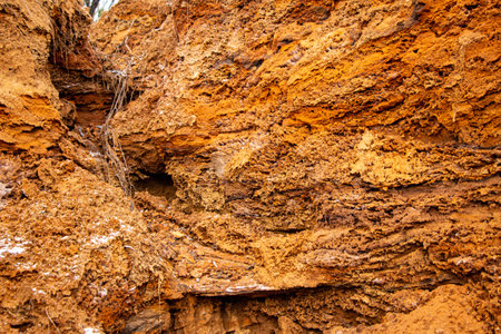 Textural sand, with a relief surface, multi-colored layers and different in size of granules, in an...