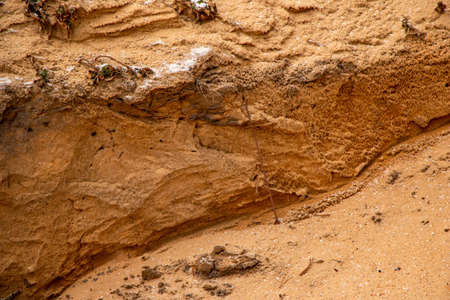 Textural sand, with a relief surface, multi-colored layers and different in size of granules, in an...