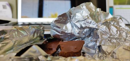 What's left of a packet of chocolate in an afternoon at the office.の写真素材