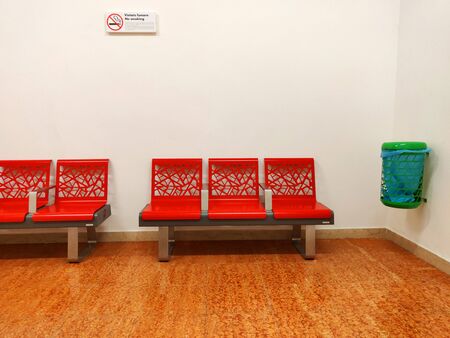Benches inside the waiting room of a small train station.の写真素材
