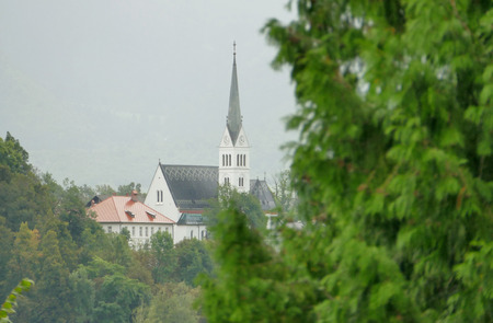 Church on island in the middle of Bled lake in Slovenia during the rain weather.の写真素材