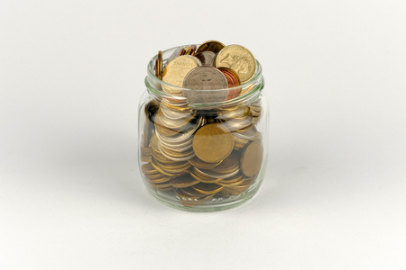 Pile of coins isolated on white backgroundの写真素材
