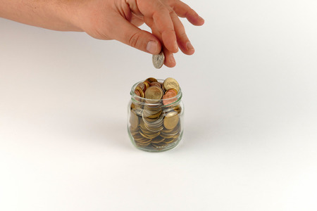 Hand mimic with pile of coins isolated on white background