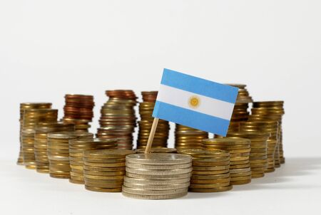 Argentina flag waving with stack of money coinsの写真素材