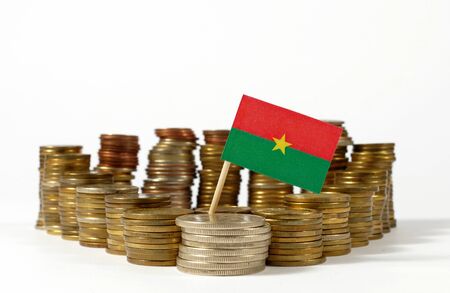 Burkina Faso flag waving with stack of money coinsの写真素材