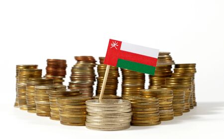 Oman flag waving with stack of money coinsの写真素材