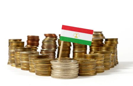 Tajikistan flag waving with stack of money coinsの写真素材