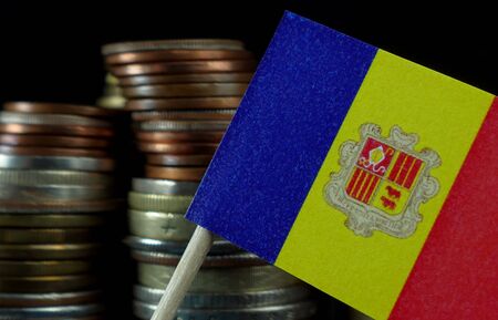 Andorran flag waving with stack of money coins macroの写真素材