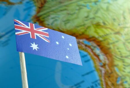 Australian flag with a globe map as a background macroの写真素材