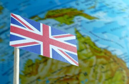 Great Britain flag with a globe map as a background macro
